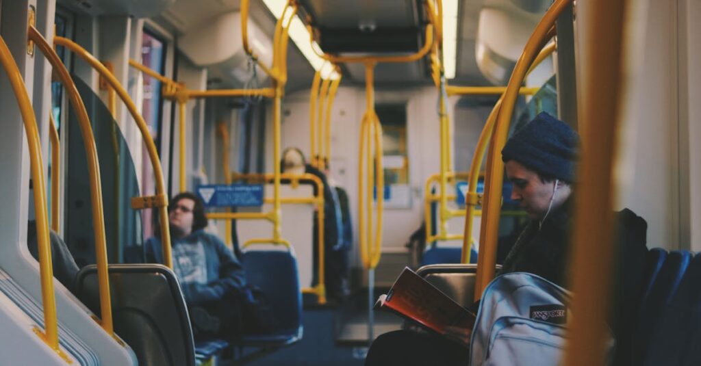 Commuters engaging in reading and relaxing on a modern Portland tram.